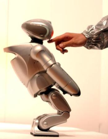 Sony robot being touched by human hand